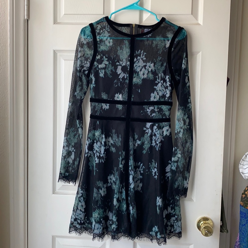 Long sleeve lace dress with zipper on back, has stretchy and adjusts to figure.
